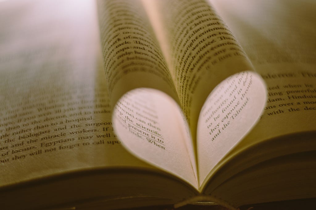 Close up of book pages forming a heart