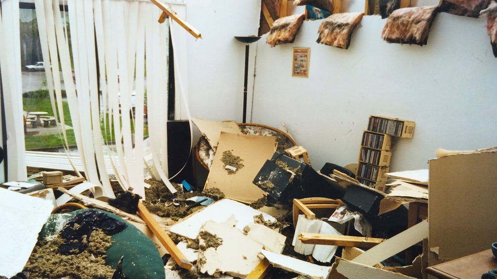 A photo of our apartment after the tornado, filled with insulation from the ceiling and broken furniture