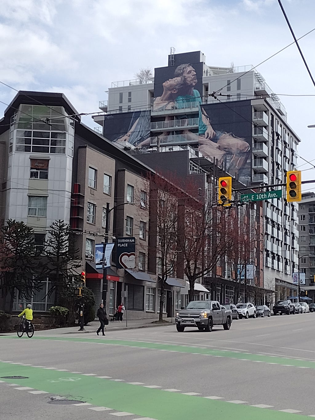 a photo of buildings in East Side Vancouver, with a mural on the side of an apartment building