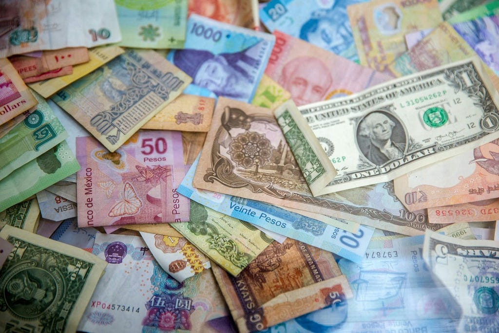 City Breaks Explorer — 10 Tips for Travelling Cheap — World Currency Bank Notes