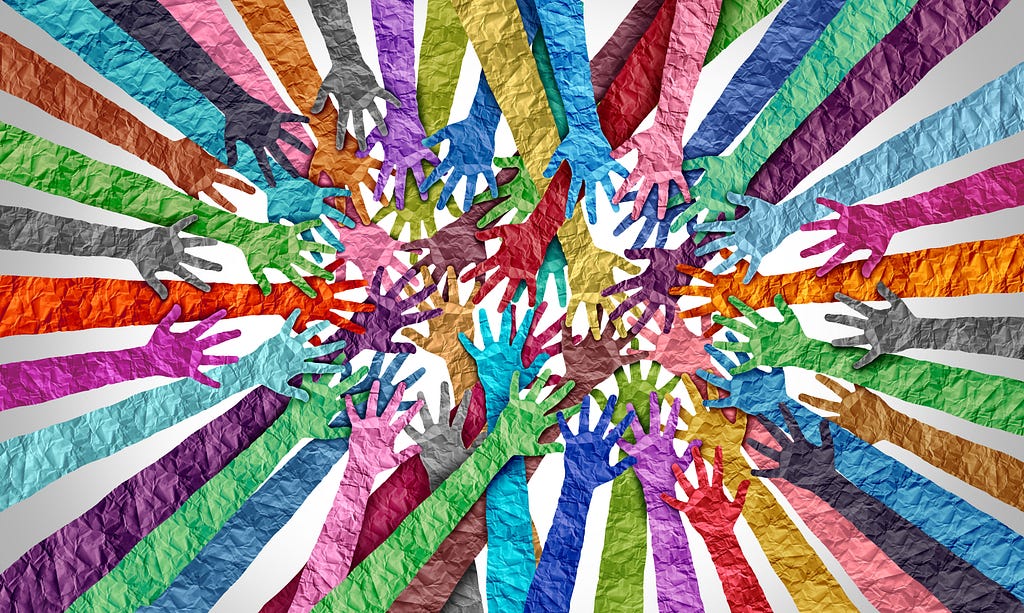 A rainbow-colored collection of arms, hands, and fingers, all reaching in from the edge of the image towards the center of the image, where they all meet, overlap, and touch.