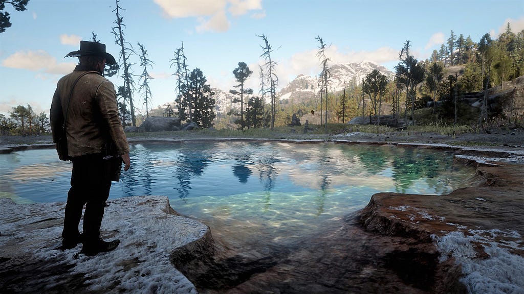 Arthur looking a majestic blue pond in the wilderness