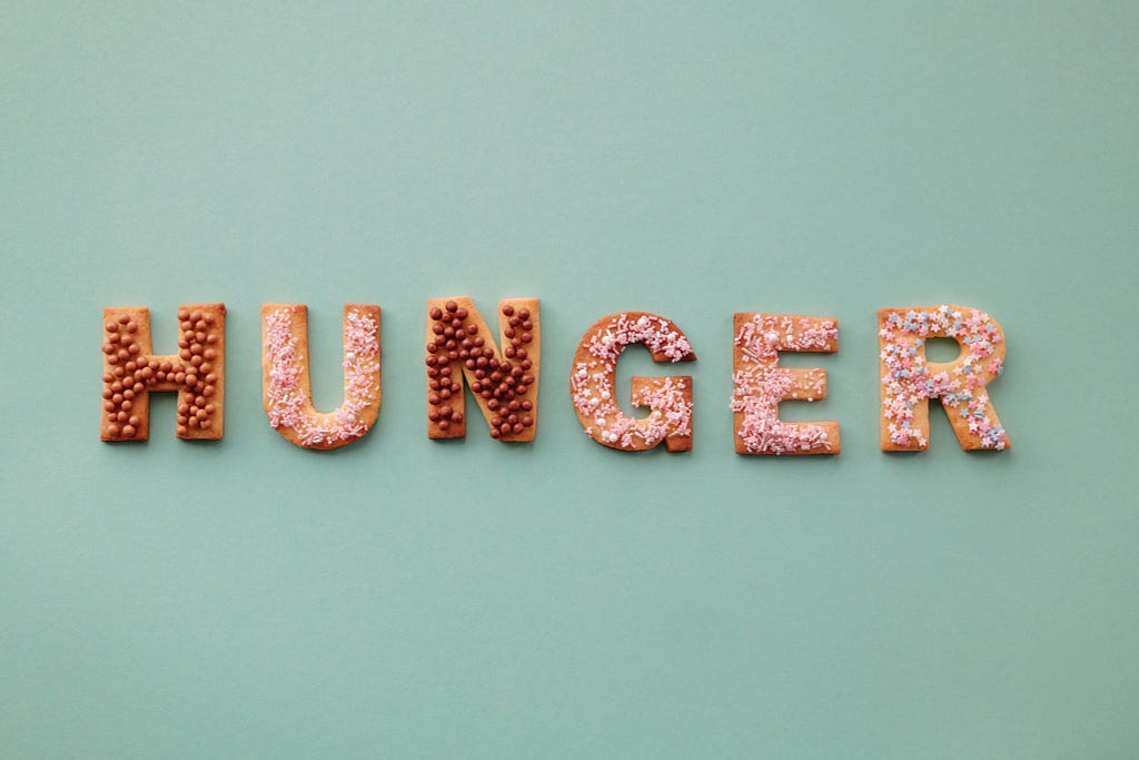 Cookies that are cut into letters and arranged to spell the word “HUNGER”