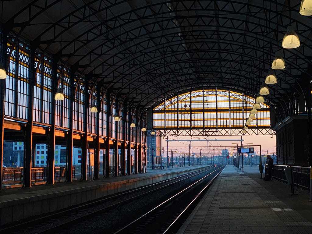 A person waiting for a train at the train station