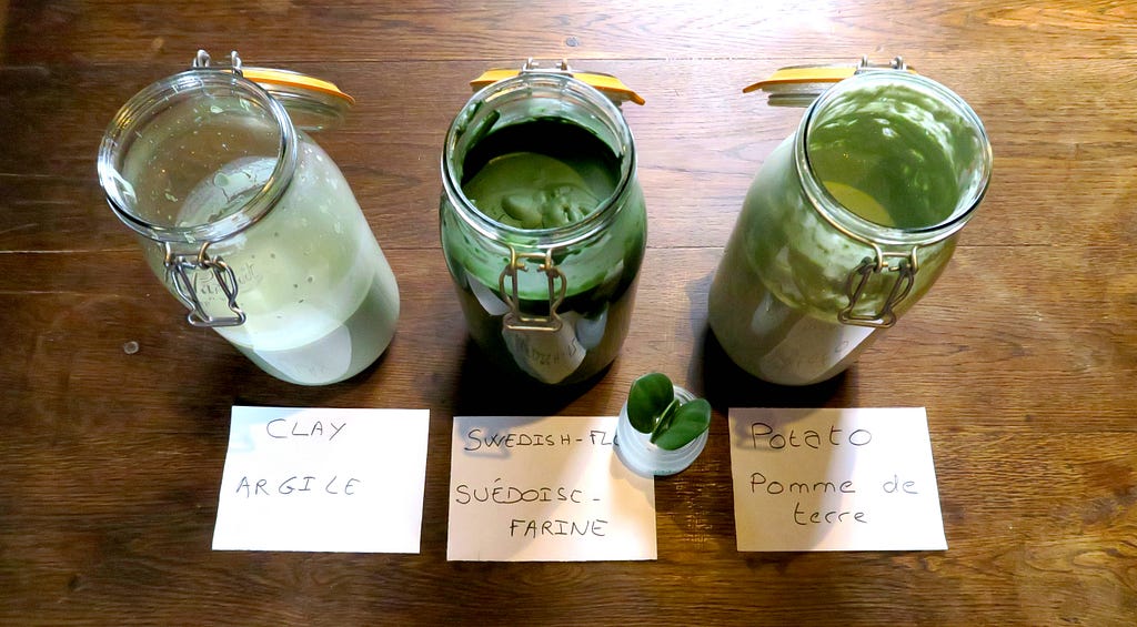 3 jars containing home wooked natural paints : clay paint, flour paint & potato paint, in green