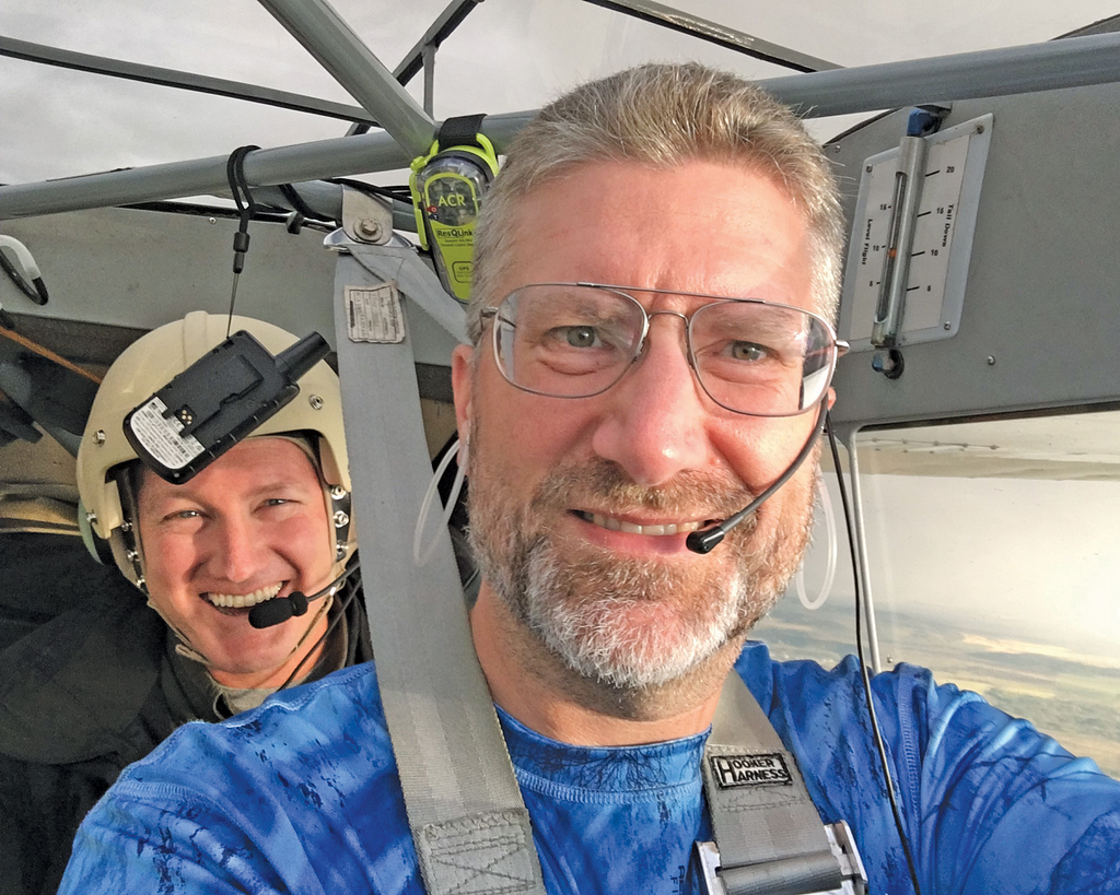 Photo of two people in an airplane.