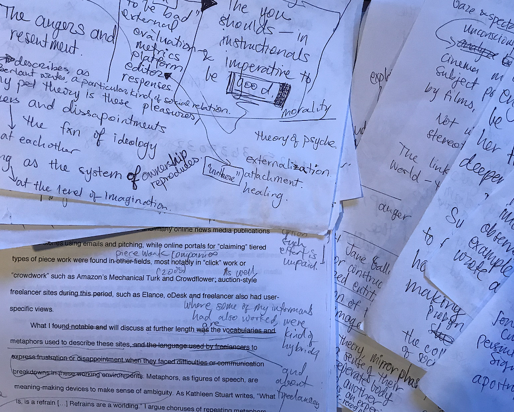 Papers with typed words, handwriting in margins.