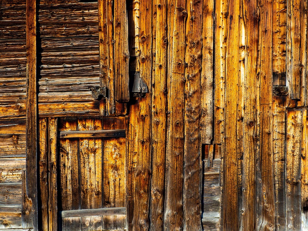 Rustic wooden door, nearly indistinguishable from planks of wood