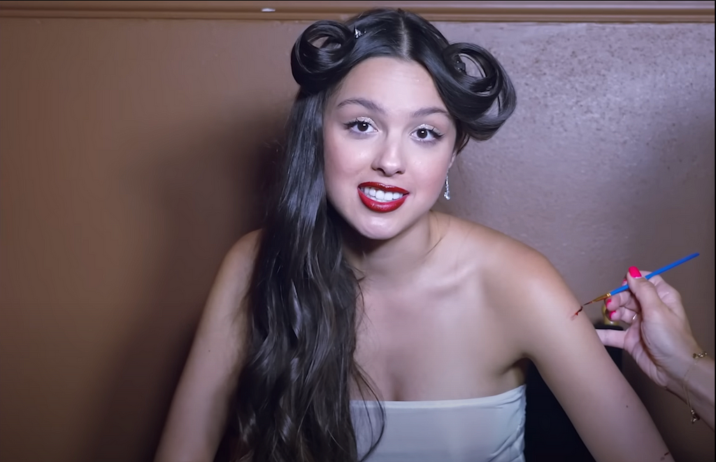 Olivia Rodrigo BTS of her vampire music video getting her SFX makeup done