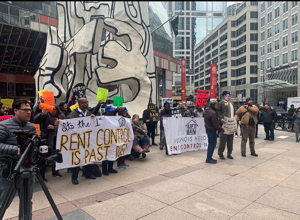Image of group of people at rally to support rent control