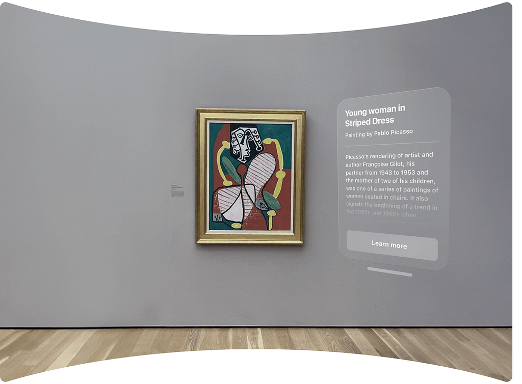 Inside a museum, an AR overlay provides information on a real painting, ‘Young woman in Striped Dress’ by Pablo Picasso, with an option to learn more about the artwork and the artist.