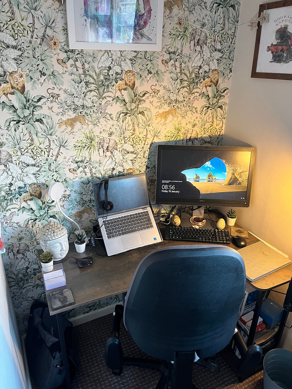 A desk with a laptop and monitor set up.
