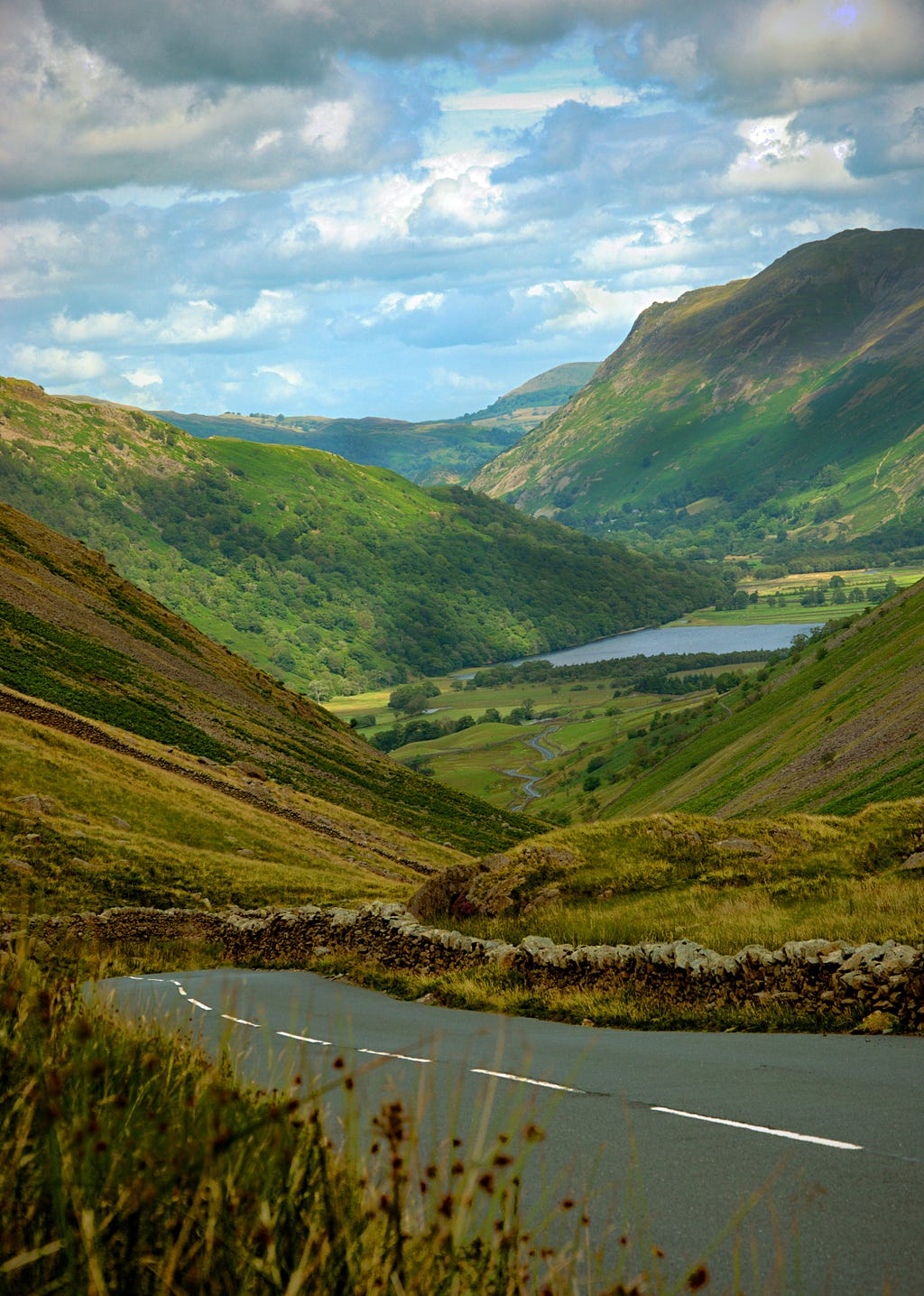 This image of a winding road through a lush, green valley with mountains in the background beautifully captures the essence of life’s journey. The road symbolizes the path we travel, often with twists and turns, while the expansive landscape represents the vastness and potential of life when we trust in a higher plan.