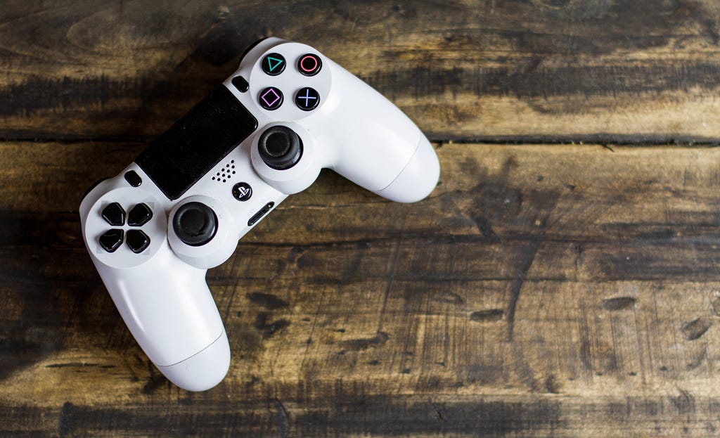 A controller lying dormant on a wooden surface