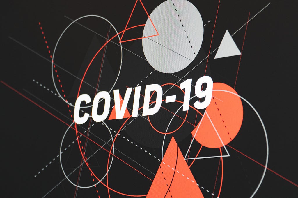 Text of “CoVID-19” on top of shapes in red and white