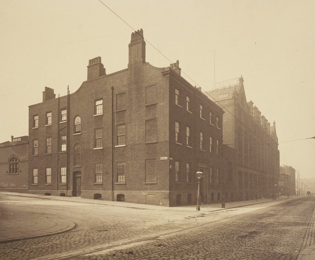 Sepia photograph of front elevation of the Owens college.