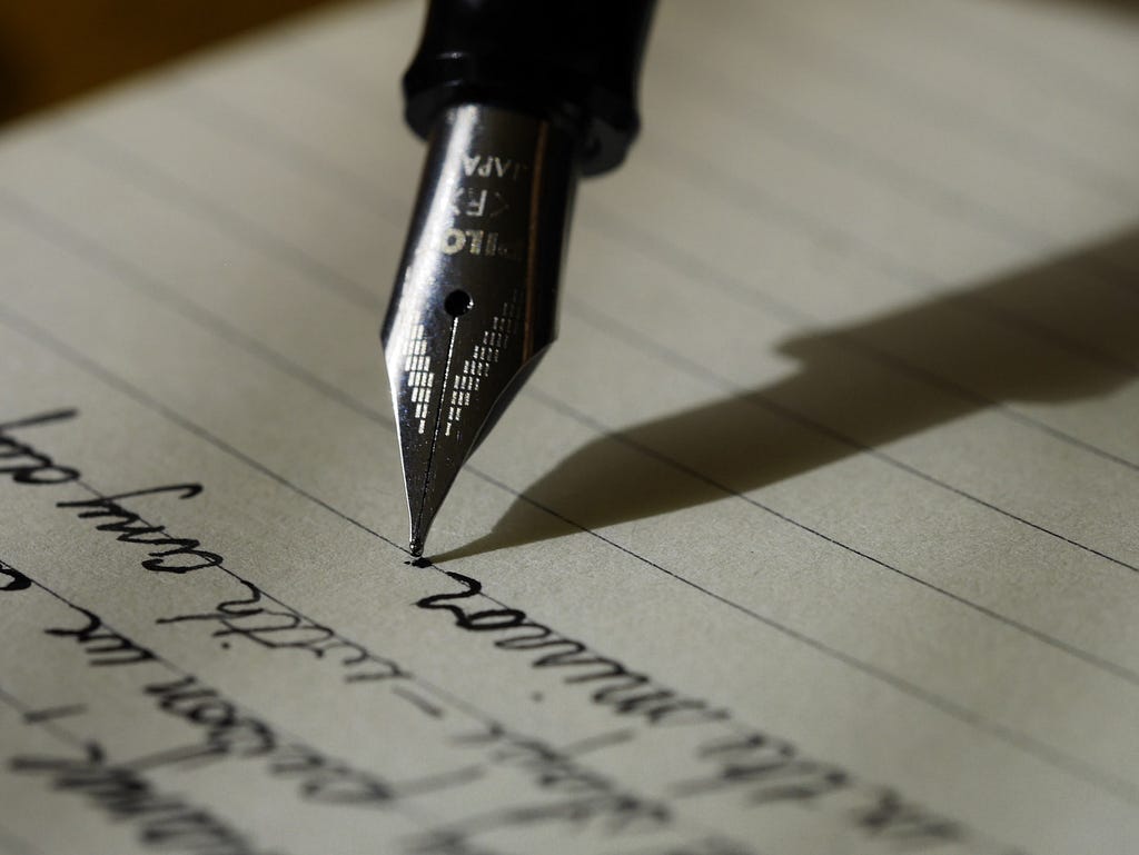 Fountain pen on black-lined writing paper