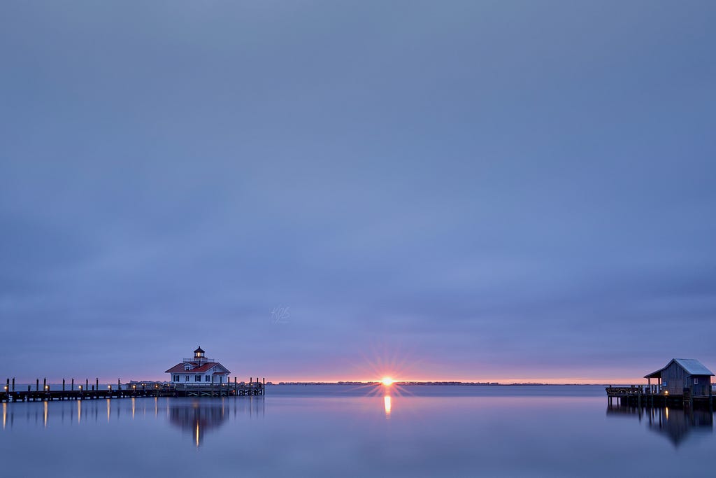 Sun rises with dazzle over Manteo lighthouse