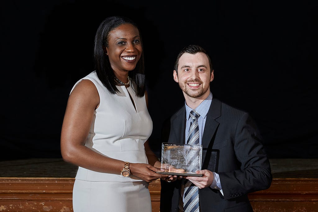 Photo of Tanya Walker receiving her Arch Award from Chad Fullerton, Arch Award recipient of 2014.