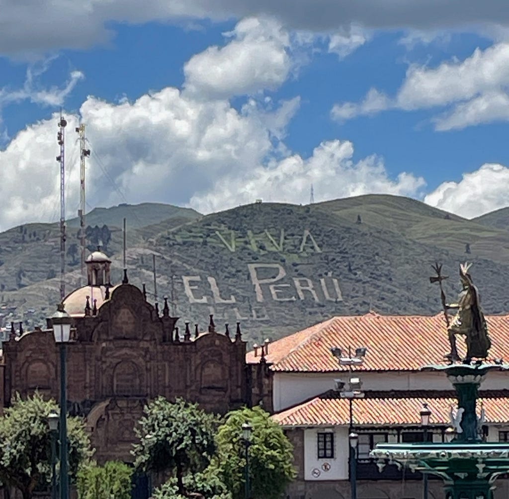 View of a mountain inscribed with Viva El Peru, from the main Plaza de Armas in Cusco.