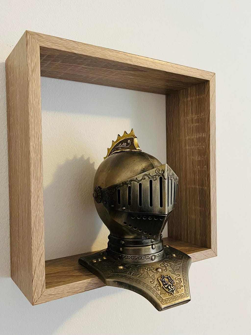 A miniature knight’s helmet on a shelf