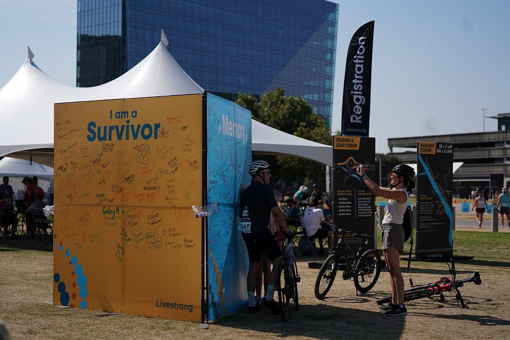 Wall at outdoor event with names of cancer survivors