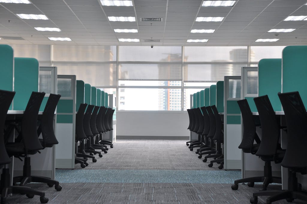 Empty office due to layoffs. Photo by kate.sade on Unsplash.