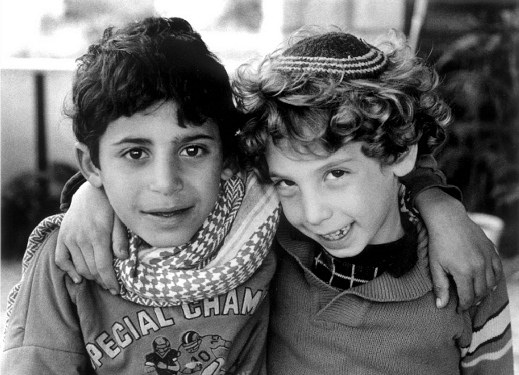 A Palestinian boy and Israeli boy being friends with one another