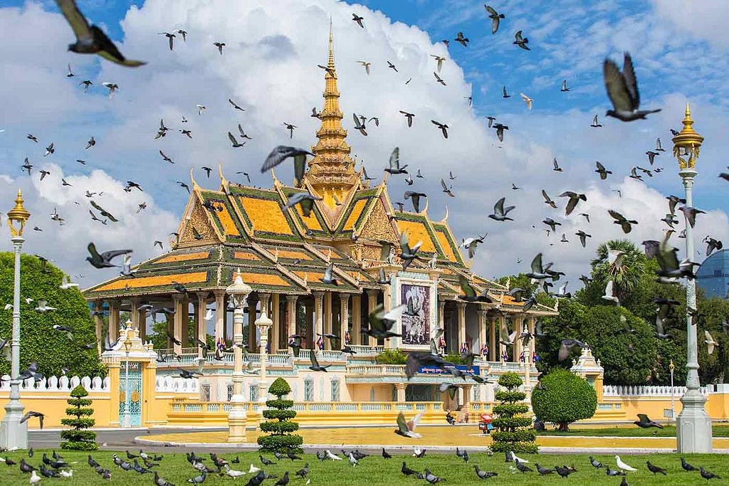 A golden building with many birds