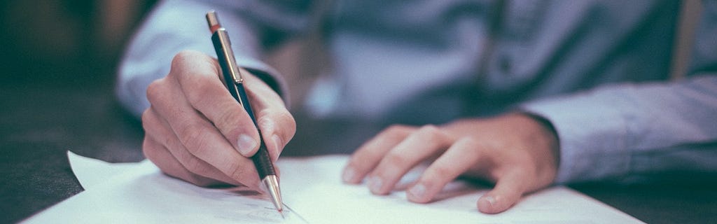 A man writing on paper