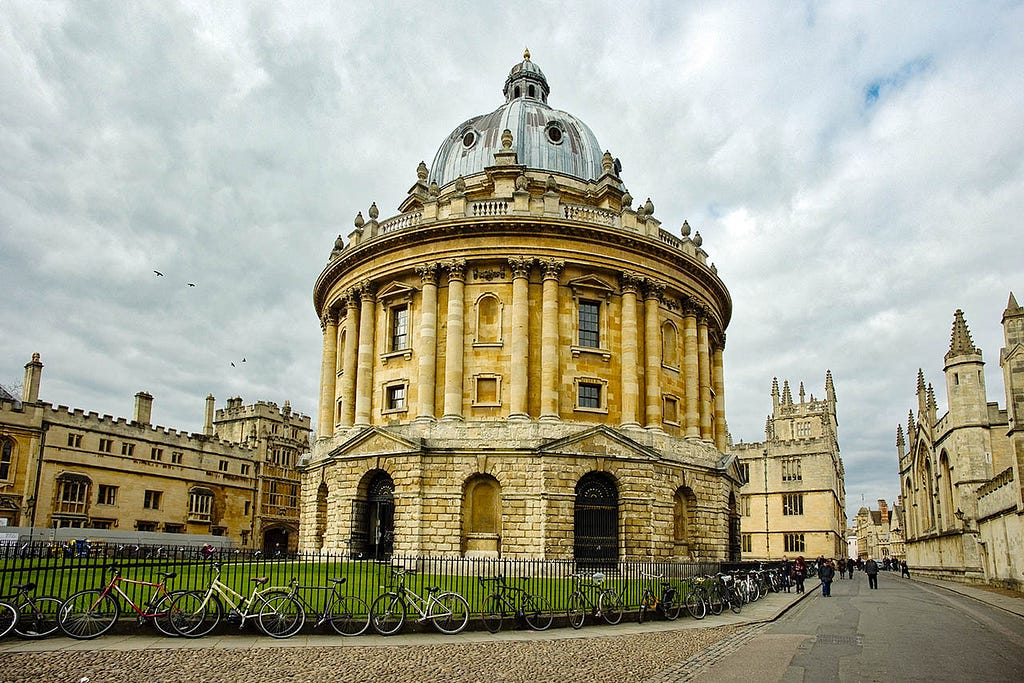 a yellow brick circular building with a domed roof in oxford