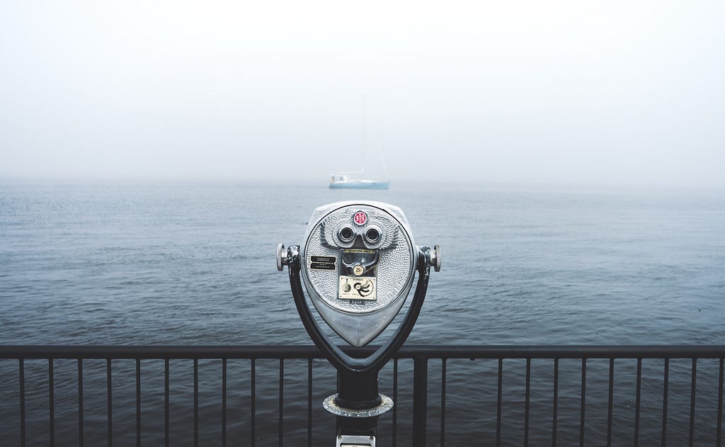 Picture yourself at the end of a pier, feel the slight bounce of the wooden floorboards beneath your feel, and touch the black iron railing still damp with the morning fog. Out on the water you see a light blue blue boat and you peer through a set of binoculars to see what you can see.