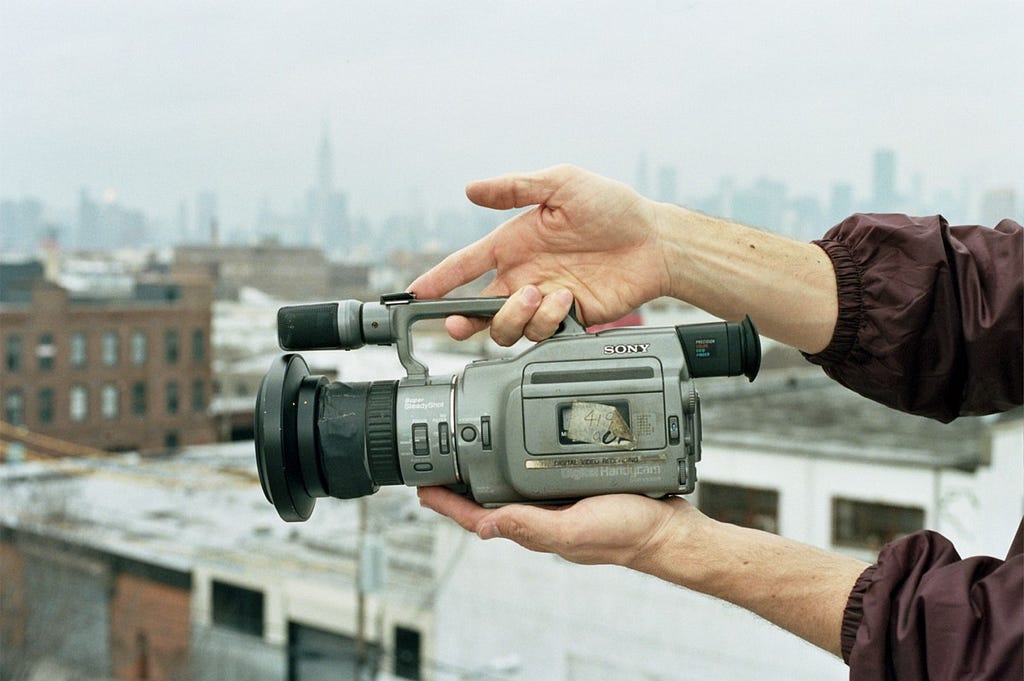 Well-used Sony VX1000 camera in someone’s hands.