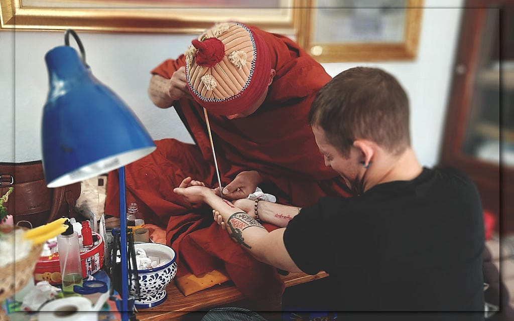 An acquaintance of mine receiving a sak yant tattoo from a monk in Pai, Thailand.