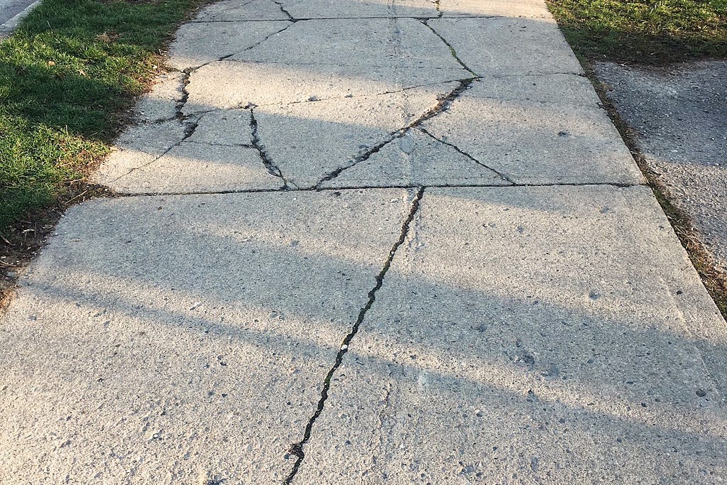 random sidewalk cracks that reveal an arrow