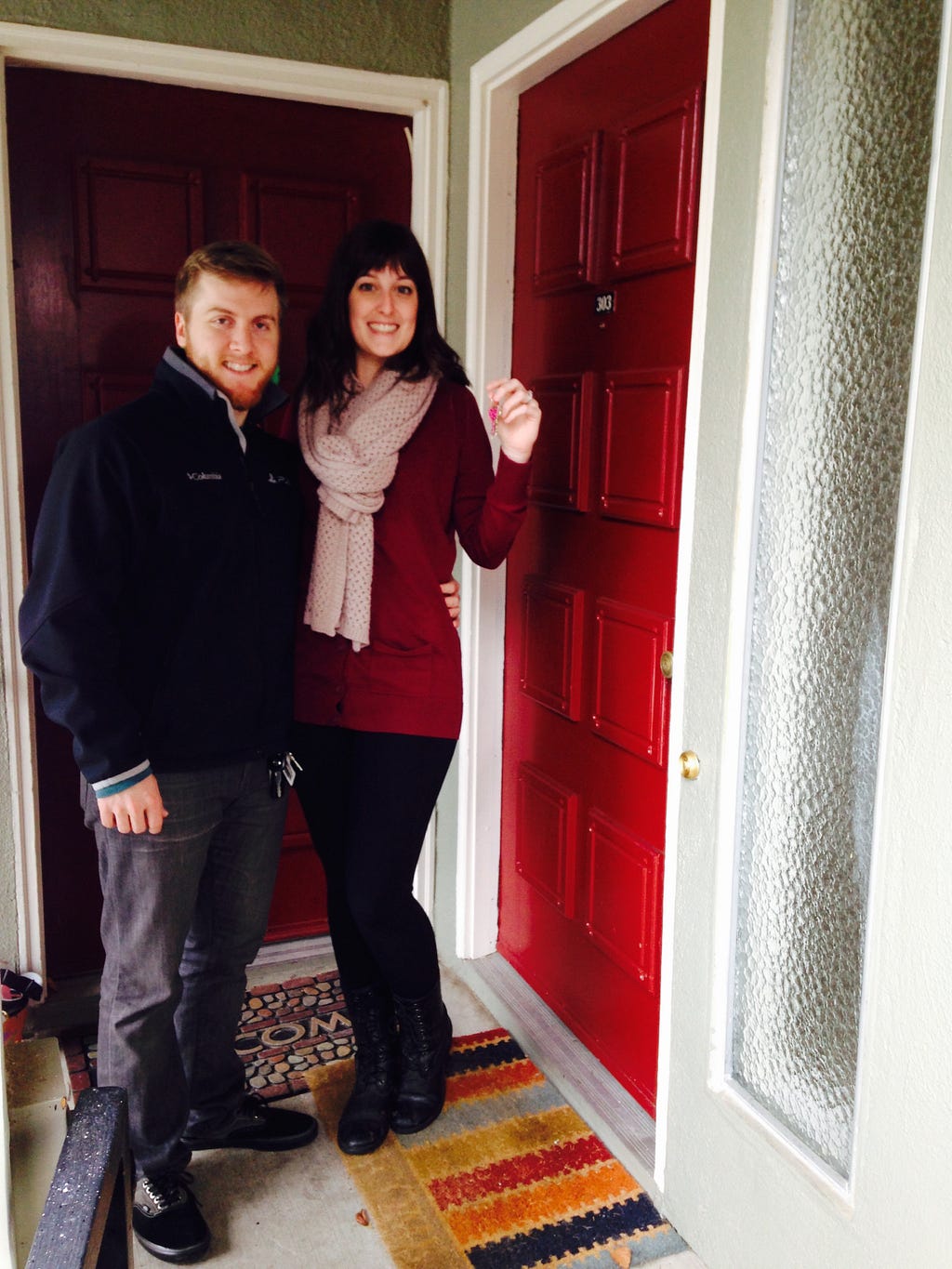 Standing in front of our first home with the keys!