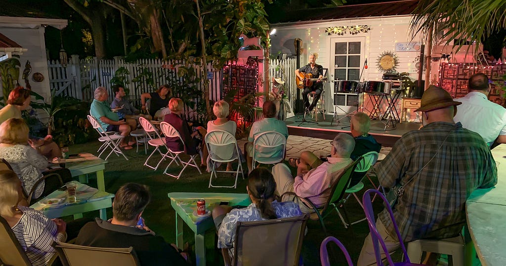 Key West songwriting legend C.W. Colt is performing in front of a small audience in an intimate setting in paradise.