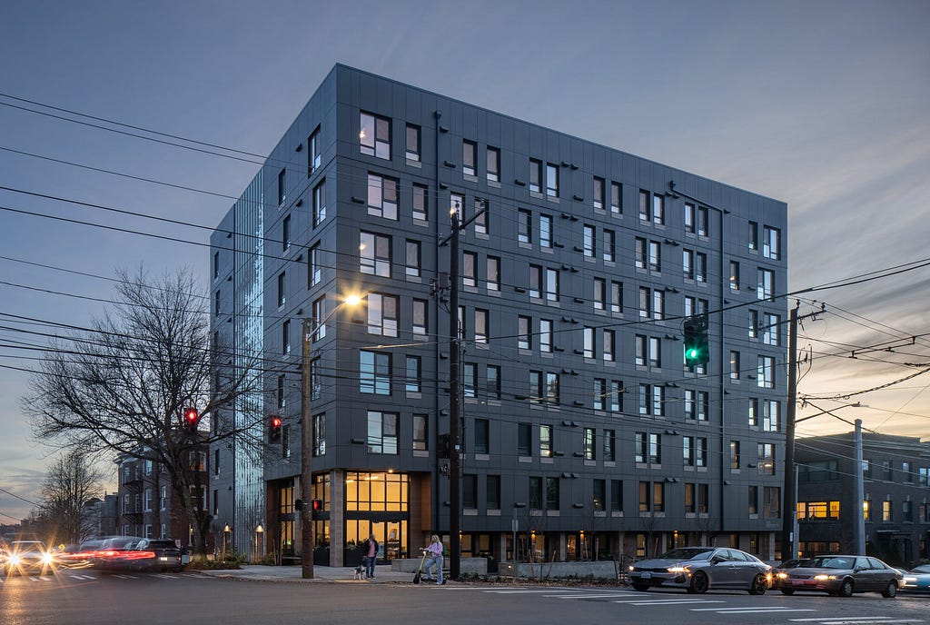 “The 8-story, centrally located building provides 126 units of workforce housing alongside an outdoor courtyard, bike parking, retail, and laundry. Units are compact, averaging 400 SF. The project provides a critical element of our urban housing — missing middle housing targeting 60–100% of Area Medium Income (AMI).” -atelierjones, LLC