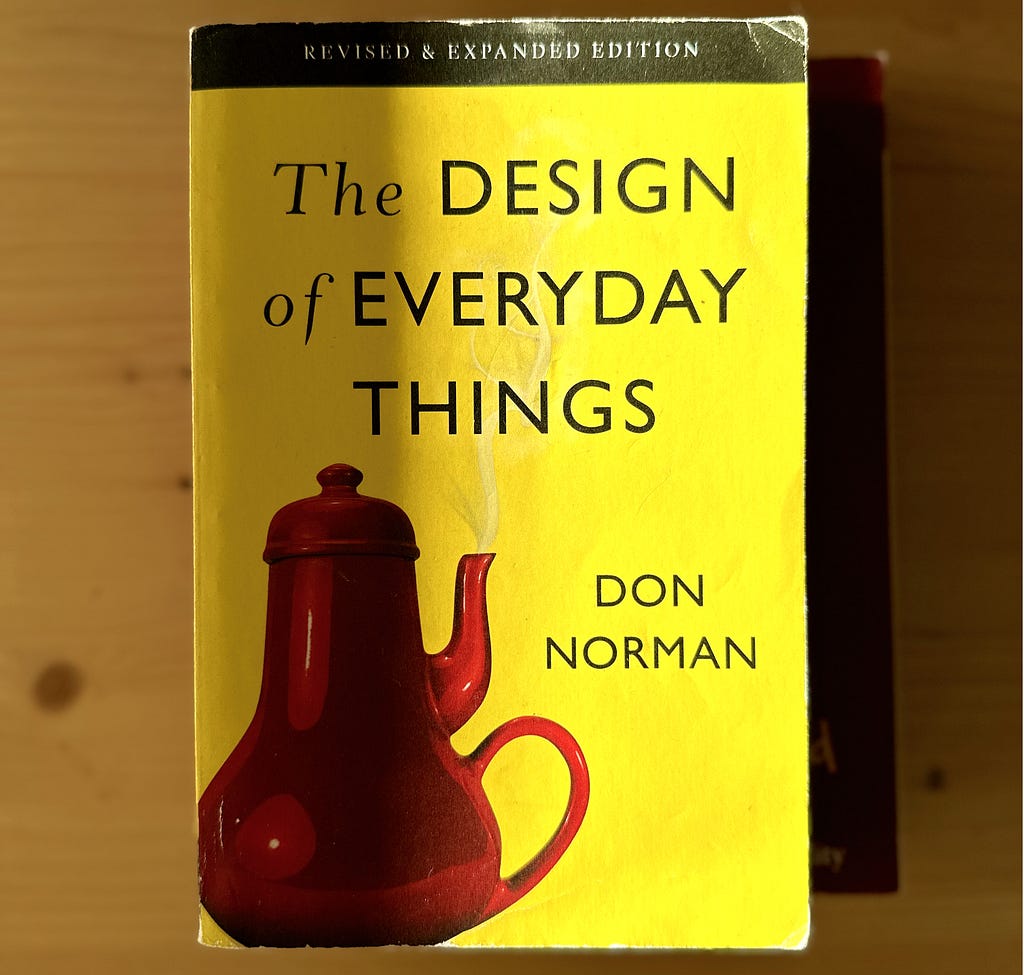 The book “The Design of Everyday Things” with a yellow cover