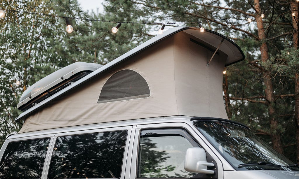 Silver campervan with pop-top roof extended