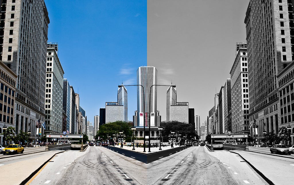 Mirrored image of a roadway, with the left side in color while the right side is black and white.