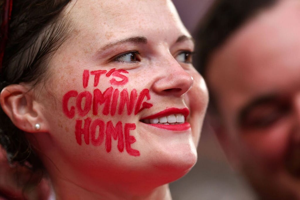 Photo of England fan with “It’s Coming Home” written on her right cheek