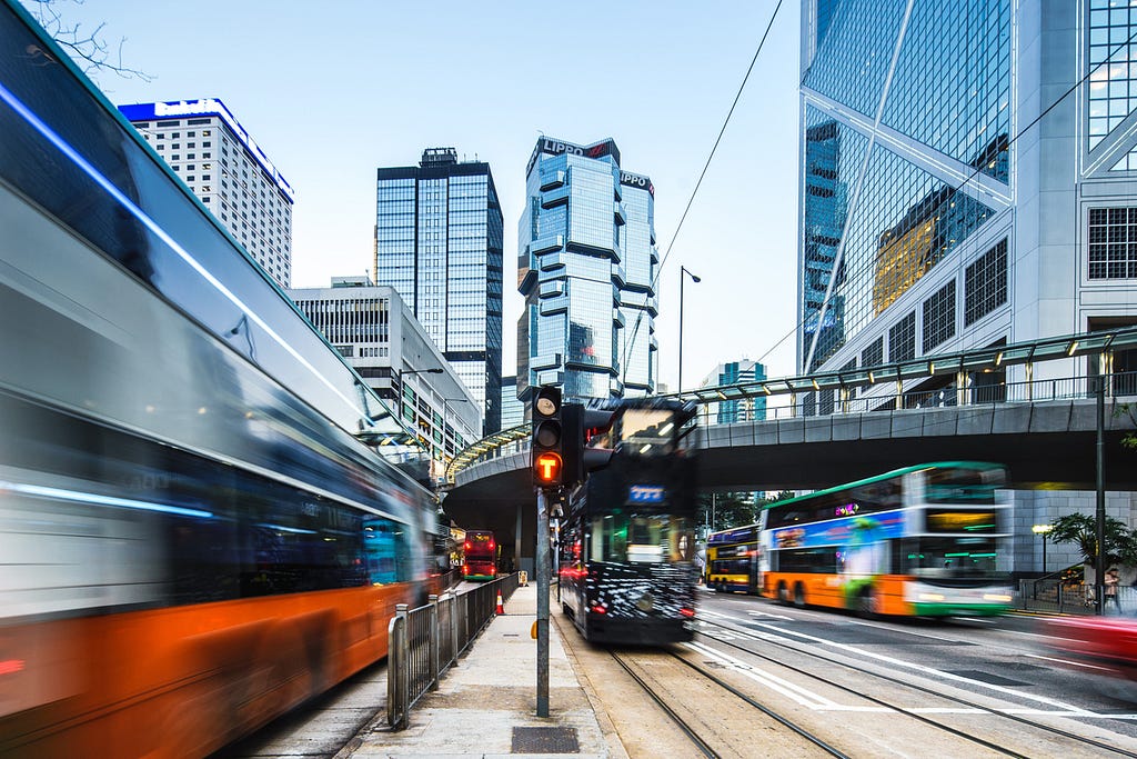 Buses speeding by slightly out of focus