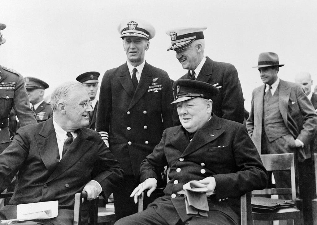 U.S. President Franklin D. Roosevelt (L) and UK Prime Minister Winston Churchill seated on the quarterdeck of HMS Prince of Wales off the coast of Newfoundland, Canada, August 10, 1941. Photo by IMAGO/piemags via Reuters Connect