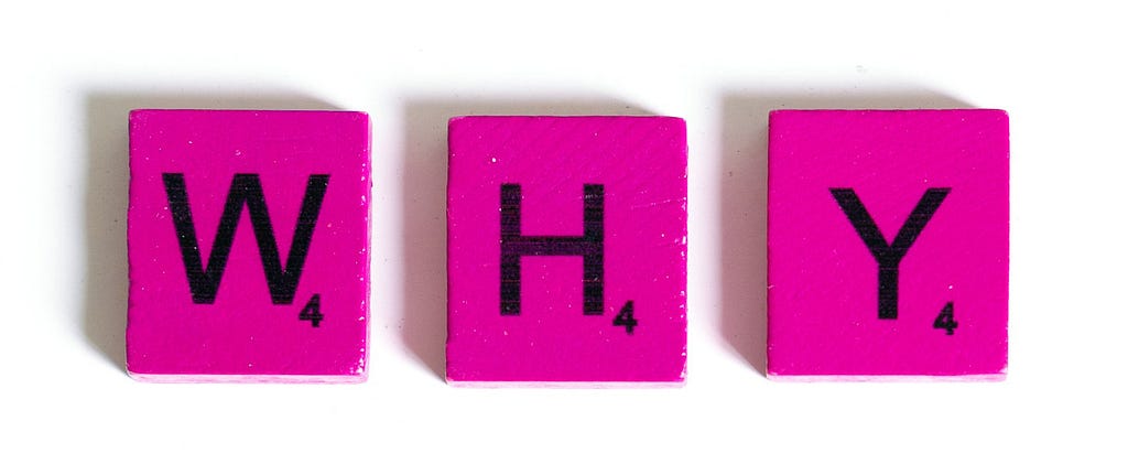 Pink Scrabble tiles spelling out why