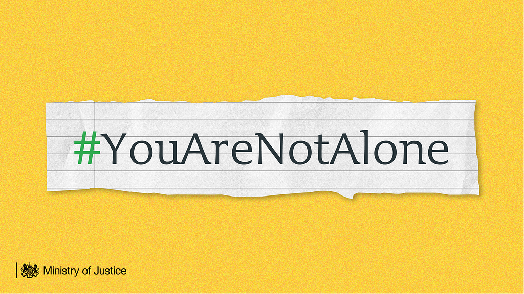 A piece of paper ripped from a noteback with the hashtag ‘YouAreNotAlone’.