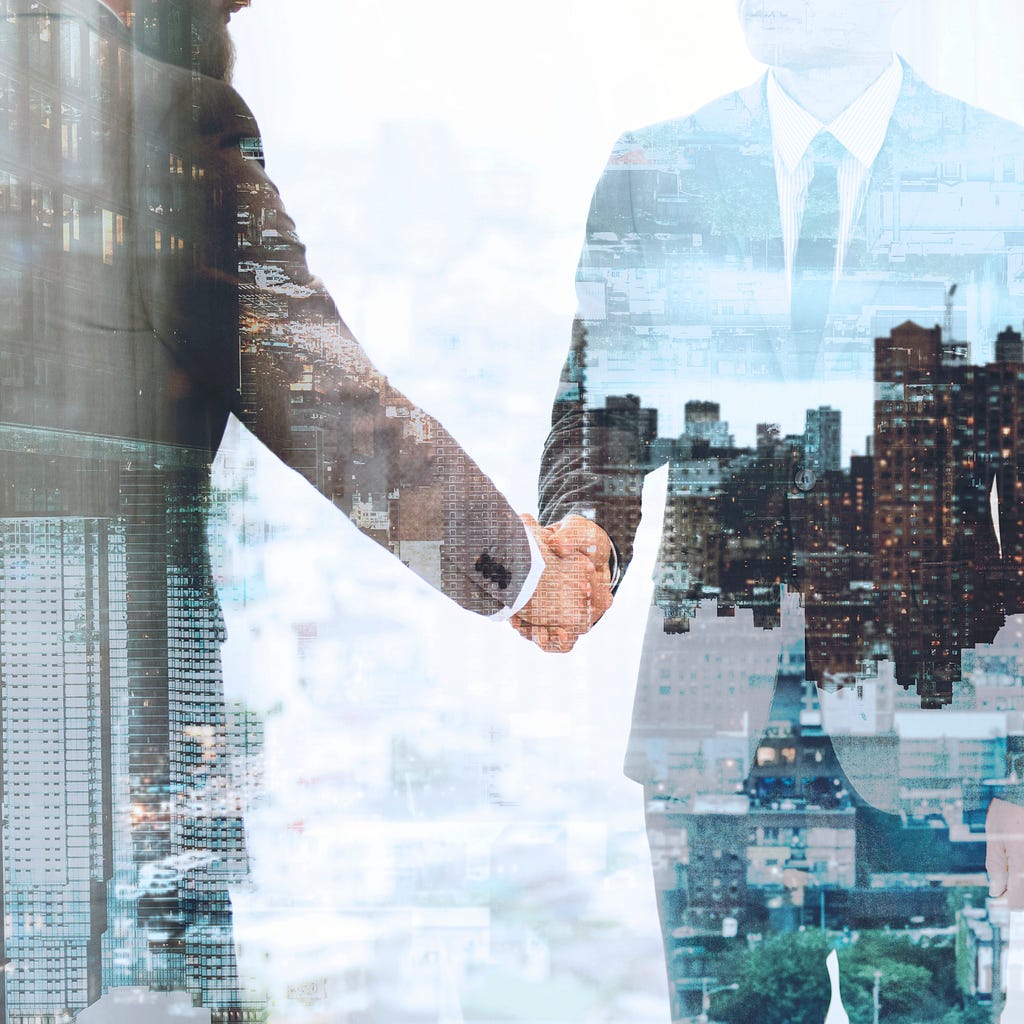 A businessman shakes hands as he finalizes a deal to collaborate with a recruitment agency, symbolizing partnership and professional collaboration in the job market.