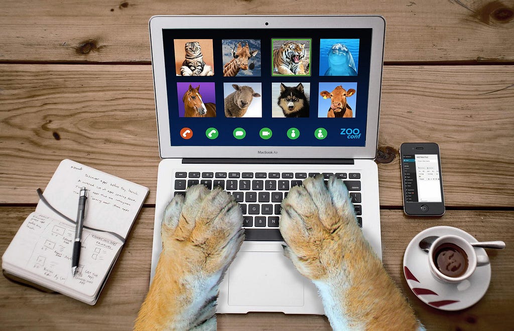 Parody image imagining how it would look to be a lion at work. The lion’s paws are typing on a laptop while attending a “zoo” conference online meeting. You can see images of different animals (like a horse, a cat, and a bison) on the “zoo” call.