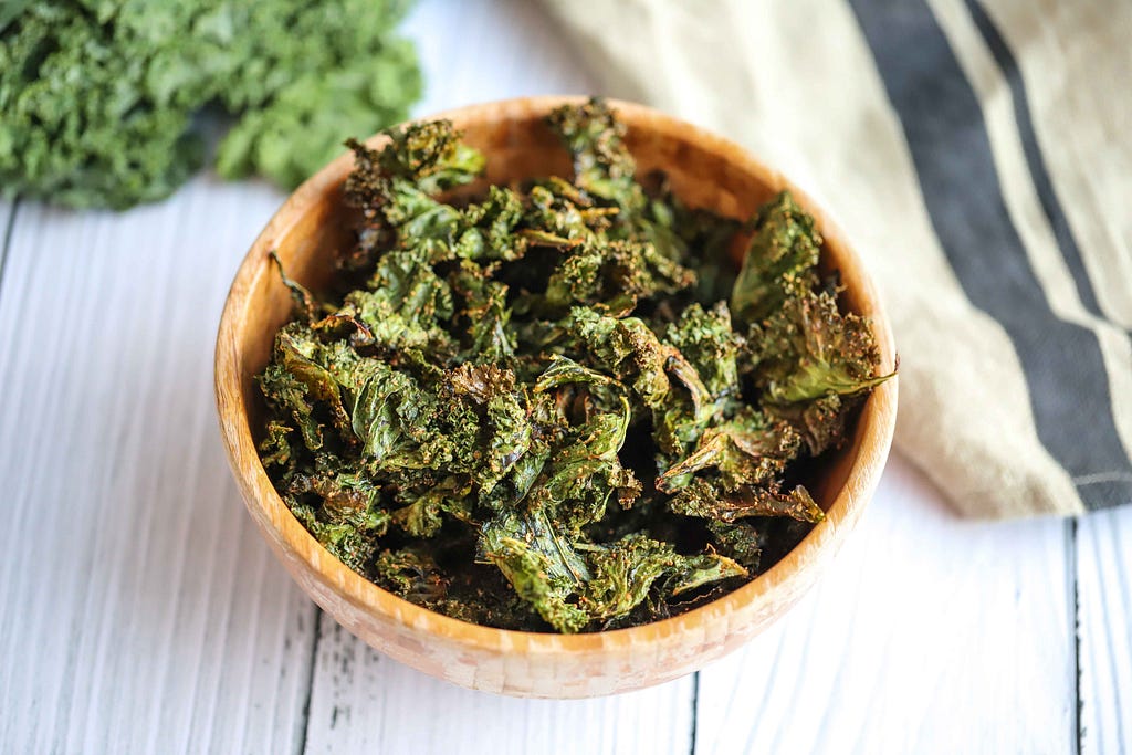Wooden bowl filled with kale chips