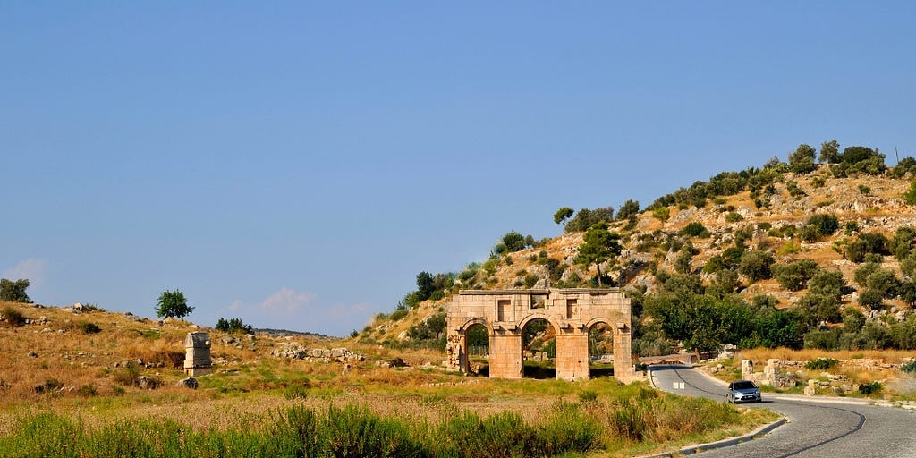 Patara, ancient Lycia, Modern-day Republic of Turkey: Ruins of the first century AD, triple-arched, Roman gateway at the entrance to the ancient city.